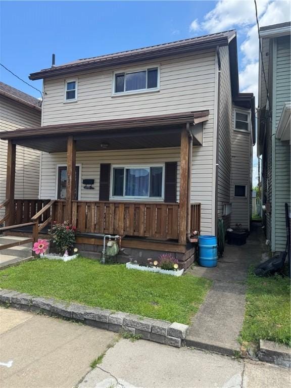33 Spruce St, Natrona, PA 15065 - view of front of house featuring covered porch and a front yard