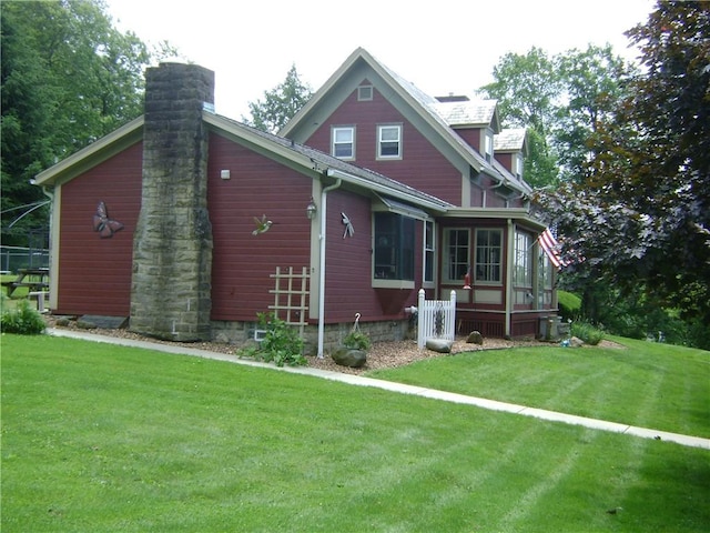 404 Scipio, Jamestown, PA 16134 - back of house featuring a sunroom, a chimney, and a lawn