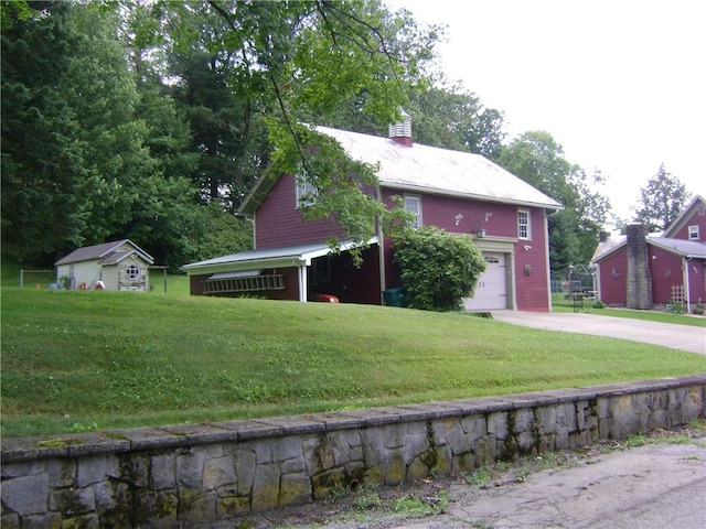 404 Scipio, Jamestown, PA 16134 - view of property hidden behind natural elements featuring a garage, driveway, a chimney, and a front yard