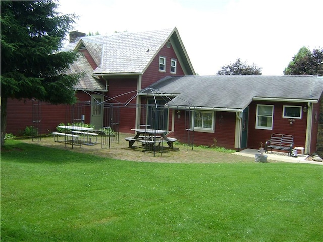 404 Scipio, Jamestown, PA 16134 - rear view of house featuring a yard, a chimney, and a shingled roof