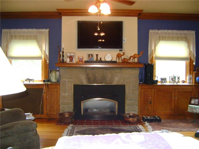 404 Scipio, Jamestown, PA 16134 - living room featuring ornamental molding, a fireplace with flush hearth, a ceiling fan, and wood finished floors