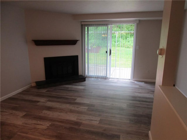 43 Shadow, Whitehall, PA 15227 - unfurnished living room with wood finished floors and a fireplace with raised hearth