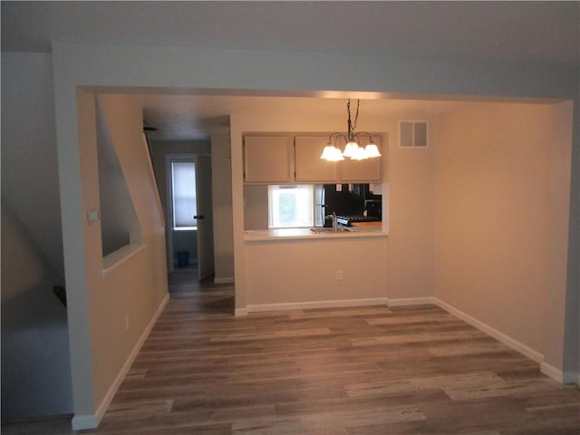 43 Shadow, Whitehall, PA 15227 - unfurnished dining area featuring a chandelier and dark wood-style flooring