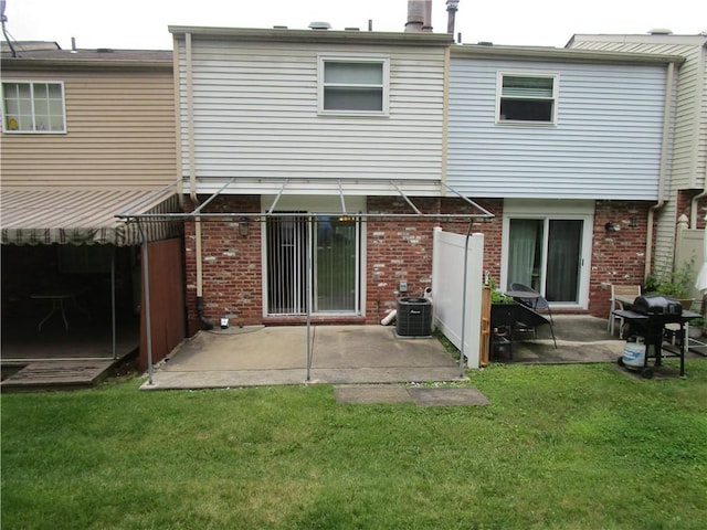 43 Shadow, Whitehall, PA 15227 - rear view of house with brick siding, a patio area, and a lawn
