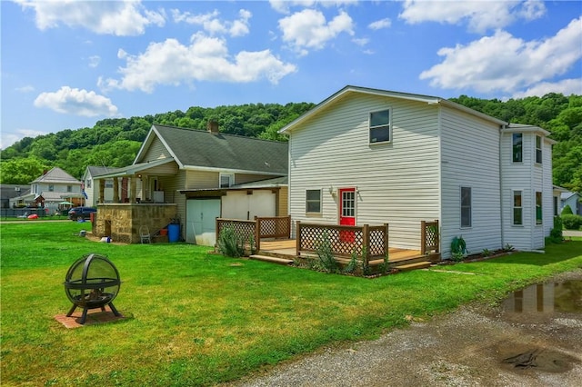 516 5th St, Darlngtn Twp, PA 16115 - back of house featuring a fire pit, a wooden deck, and a yard