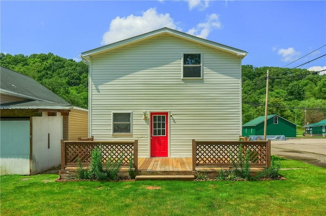 516 5th St, Darlngtn Twp, PA 16115 - rear view of property featuring a wooden deck, a lawn, and a wooded view