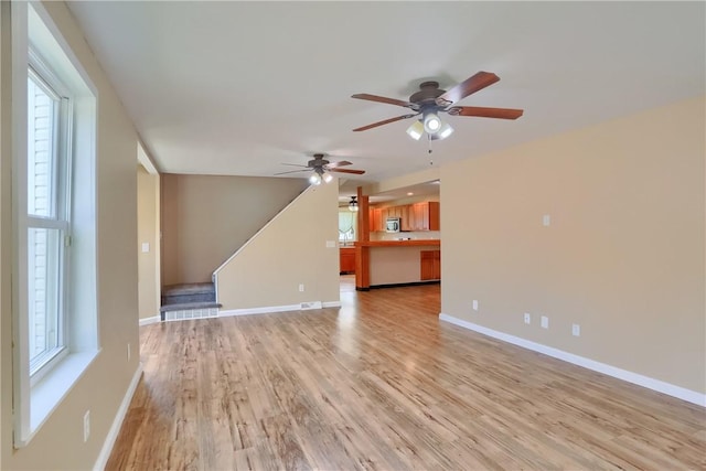 516 5th St, Darlngtn Twp, PA 16115 - unfurnished living room with ceiling fan, light wood-style flooring, plenty of natural light, and stairway