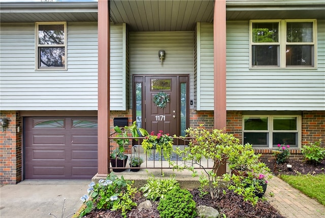 1171 La Salle Rd, Monroeville, PA 15146 - view of exterior entry featuring a garage, brick siding, concrete driveway, and covered porch