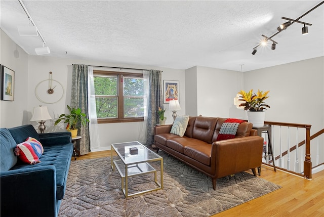 1171 La Salle Rd, Monroeville, PA 15146 - living room featuring track lighting, wood finished floors, and a textured ceiling