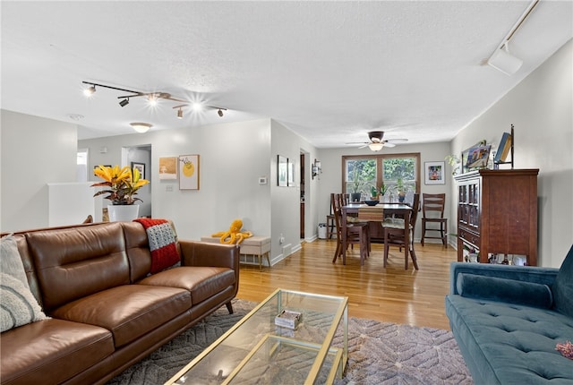 1171 La Salle Rd, Monroeville, PA 15146 - living room with track lighting, light wood-style floors, a textured ceiling, and ceiling fan