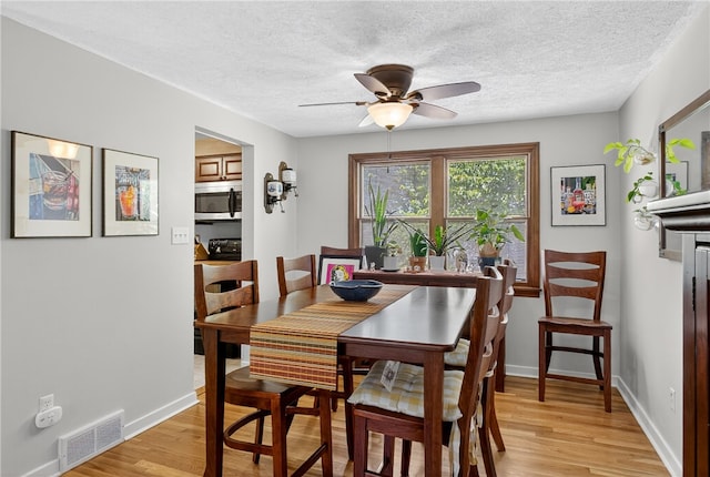 1171 La Salle Rd, Monroeville, PA 15146 - dining room featuring light wood finished floors, a ceiling fan, and a textured ceiling