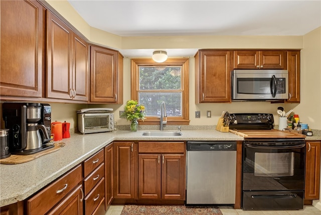 1171 La Salle Rd, Monroeville, PA 15146 - kitchen featuring stainless steel appliances, brown cabinets, and light stone countertops