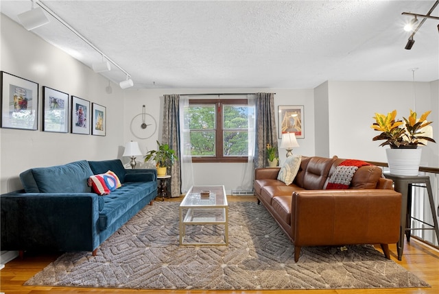 1171 La Salle Rd, Monroeville, PA 15146 - living room with track lighting, wood finished floors, and a textured ceiling