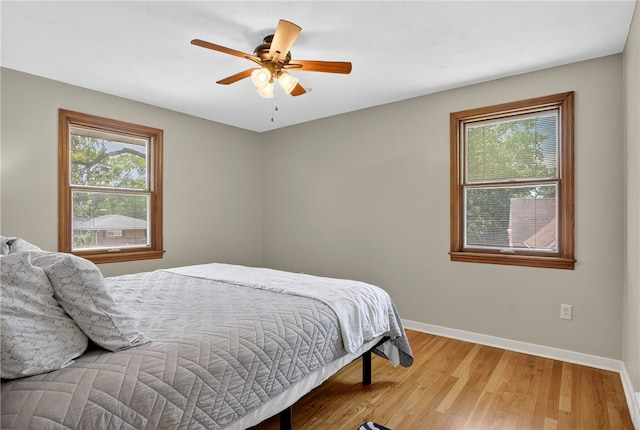 1171 La Salle Rd, Monroeville, PA 15146 - bedroom with multiple windows, wood finished floors, and a ceiling fan