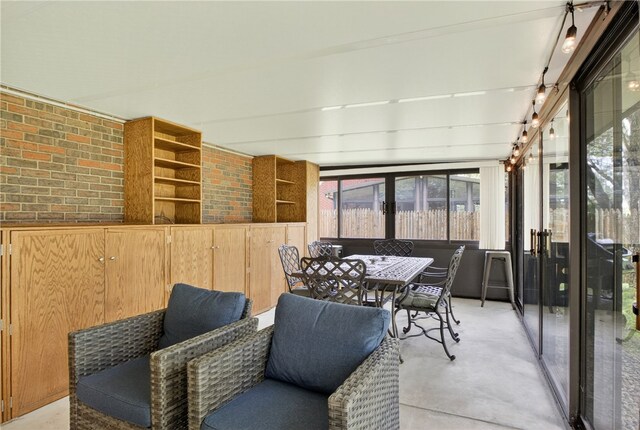 1171 La Salle Rd, Monroeville, PA 15146 - sunroom featuring brick wall and concrete floors
