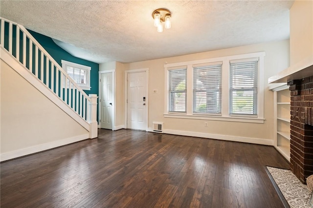 2072 Dartmore St, Overbrook, PA 15210 - entrance foyer with a fireplace, stairs, hardwood / wood-style flooring, and a textured ceiling