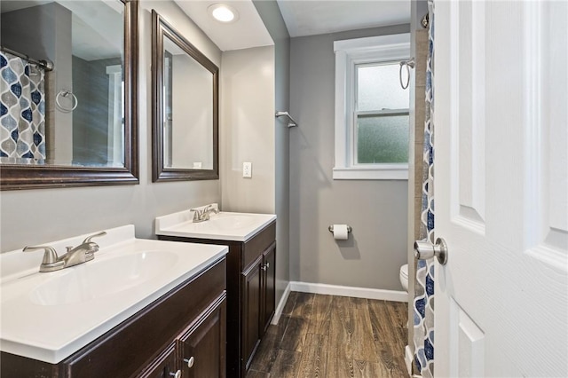 2072 Dartmore St, Overbrook, PA 15210 - full bathroom with two vanities and wood finished floors
