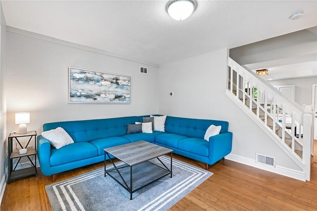312 Edith St, Mt Washington, PA 15211 - living area featuring stairs, wood finished floors, and a textured ceiling