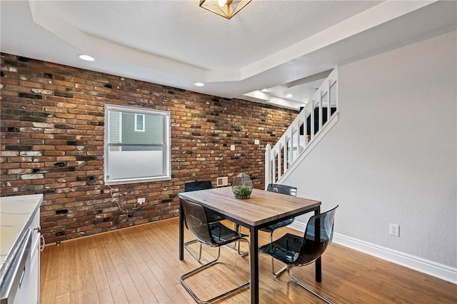 312 Edith St, Mt Washington, PA 15211 - dining area with light wood-type flooring, a raised ceiling, brick wall, recessed lighting, and stairs