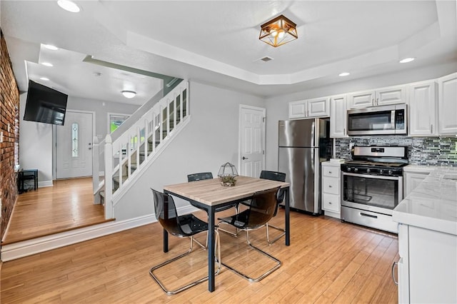 312 Edith St, Mt Washington, PA 15211 - dining space featuring a tray ceiling, stairway, light wood-type flooring, and recessed lighting