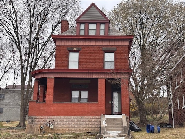 26 Carrick Ave, Carrick, PA 15210 - traditional style home with brick siding, a chimney, and covered porch