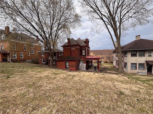 26 Carrick Ave, Carrick, PA 15210 - back of house featuring a lawn and a chimney