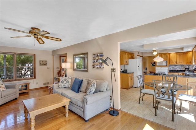 116 Rizzi Dr, Penn Twp Wml, PA 15642 - living room featuring light wood finished floors and ceiling fan