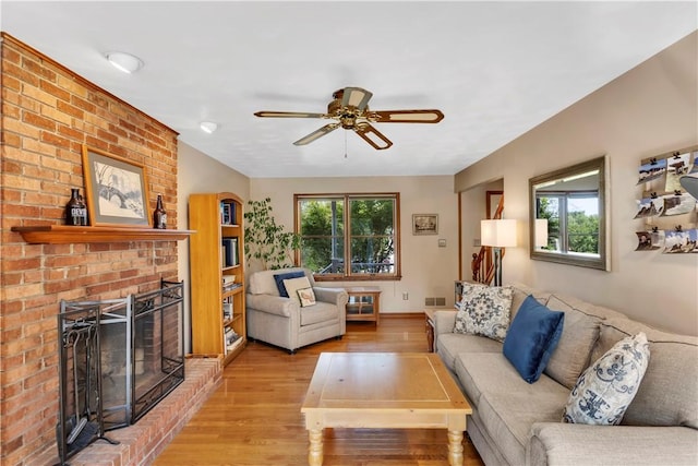 116 Rizzi Dr, Penn Twp Wml, PA 15642 - living area featuring light wood finished floors, a ceiling fan, and a brick fireplace