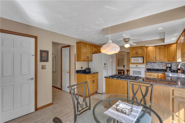 116 Rizzi Dr, Penn Twp Wml, PA 15642 - kitchen with white appliances, a ceiling fan, backsplash, hanging light fixtures, and a peninsula