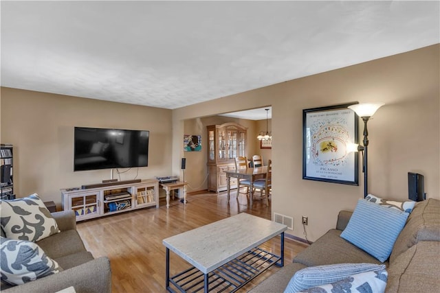 116 Rizzi Dr, Penn Twp Wml, PA 15642 - living area featuring wood finished floors and a chandelier