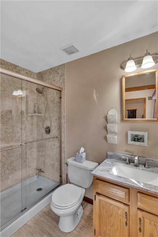 116 Rizzi Dr, Penn Twp Wml, PA 15642 - bathroom featuring vanity, a stall shower, and wood finished floors