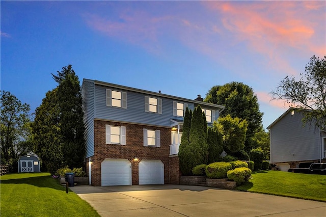 116 Rizzi Dr, Penn Twp Wml, PA 15642 - view of front facade with driveway, an attached garage, brick siding, a storage unit, and a front yard