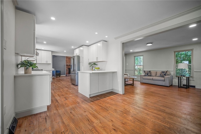 1202 Oakridge Rd, South Fayette, PA 15057 - kitchen featuring high end fridge, open floor plan, light countertops, a peninsula, and white cabinetry