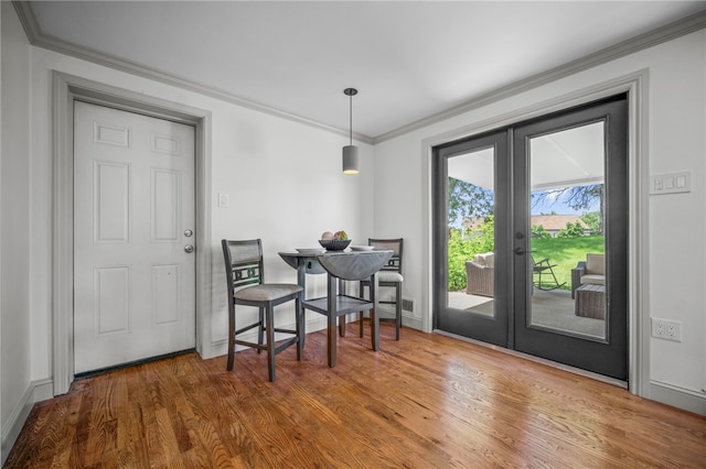 1202 Oakridge Rd, South Fayette, PA 15057 - dining space featuring french doors, wood finished floors, and ornamental molding
