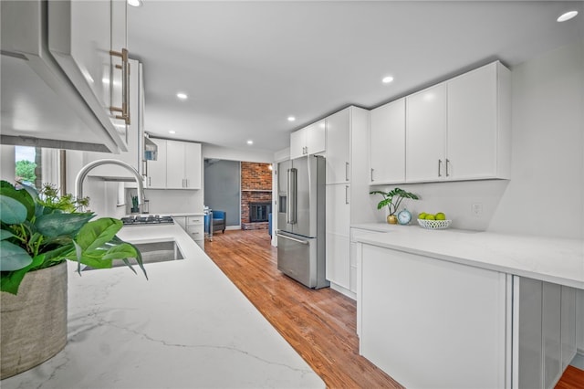 1202 Oakridge Rd, South Fayette, PA 15057 - kitchen with high quality fridge, light stone counters, white cabinets, recessed lighting, and light wood-style flooring