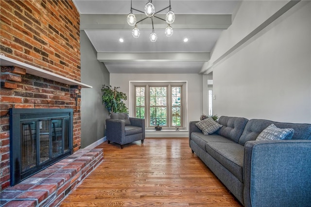 1202 Oakridge Rd, South Fayette, PA 15057 - living area featuring wood finished floors, beamed ceiling, a fireplace, and recessed lighting