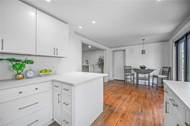 1202 Oakridge Rd, South Fayette, PA 15057 - kitchen featuring light countertops, white cabinetry, a peninsula, wood finished floors, and recessed lighting