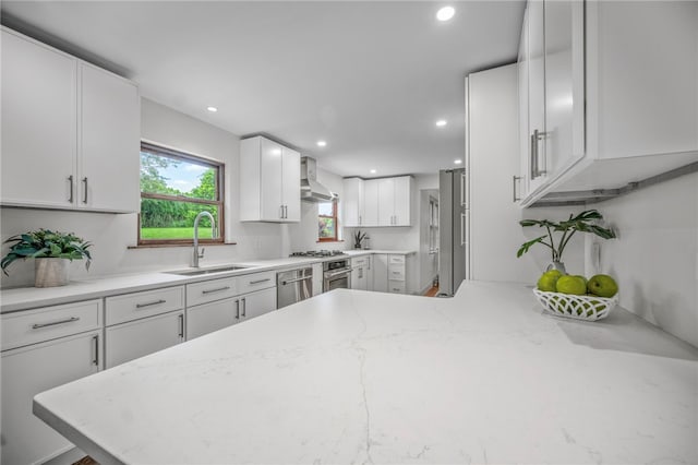 1202 Oakridge Rd, South Fayette, PA 15057 - kitchen with wall chimney range hood, dishwasher, white cabinets, recessed lighting, and light stone countertops