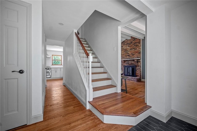 1202 Oakridge Rd, South Fayette, PA 15057 - stairway with a fireplace and wood finished floors