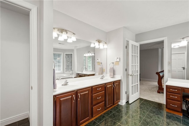 1648 Blackburn Heights Dr, Ohio Twp, PA 15143 - bathroom featuring double vanity, french doors, tile patterned flooring, and a tub to relax in
