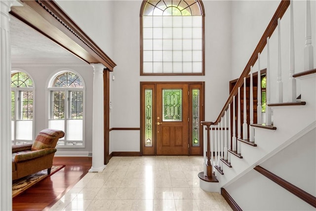 1648 Blackburn Heights Dr, Ohio Twp, PA 15143 - entrance foyer featuring decorative columns, a high ceiling, stairway, and crown molding