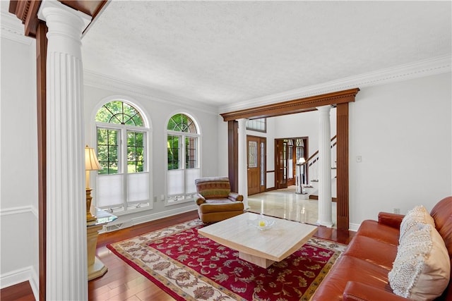 1648 Blackburn Heights Dr, Ohio Twp, PA 15143 - living room with ornate columns, ornamental molding, wood finished floors, a textured ceiling, and stairs