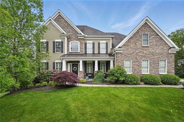 322 Dirkshire Ct, Adams Twp, PA 16046 - view of front facade featuring stone siding, covered porch, a front lawn, a standing seam roof, and a shingled roof