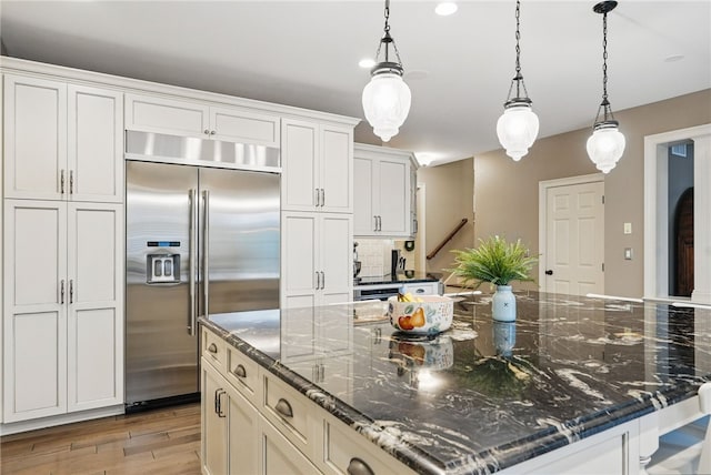 322 Dirkshire Ct, Adams Twp, PA 16046 - kitchen featuring stainless steel built in refrigerator, light wood-style floors, hanging light fixtures, a large island, and white cabinetry