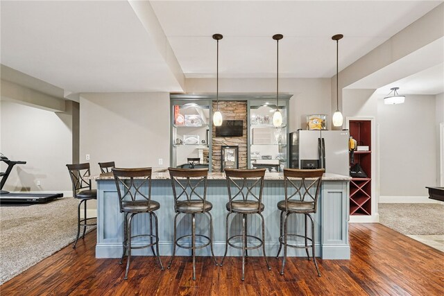 322 Dirkshire Ct, Adams Twp, PA 16046 - kitchen with stainless steel fridge, dark wood-style flooring, a kitchen bar, and hanging light fixtures
