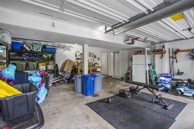 196 Oakbrook Cir, Banksville/Westwood, PA 15220 - garage featuring a garage door opener and freestanding refrigerator