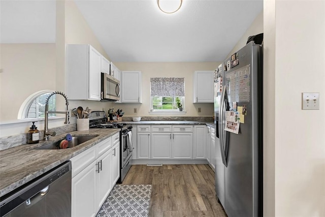 196 Oakbrook Cir, Banksville/Westwood, PA 15220 - kitchen with stainless steel appliances, white cabinets, light wood-style flooring, vaulted ceiling, and light stone counters