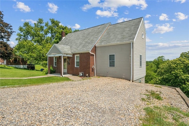 585 Dugan Way, New Kensington, PA 15068 - cape cod home featuring a chimney, a front lawn, driveway, and brick siding