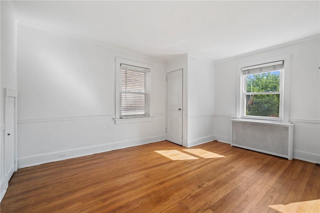 1216 Laclair Ave, Regent Square, PA 15218 - empty room featuring radiator heating unit, hardwood / wood-style floors, and crown molding