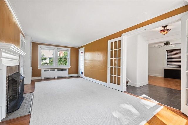 1216 Laclair Ave, Regent Square, PA 15218 - unfurnished living room featuring radiator heating unit, crown molding, a brick fireplace, wood finished floors, and ceiling fan